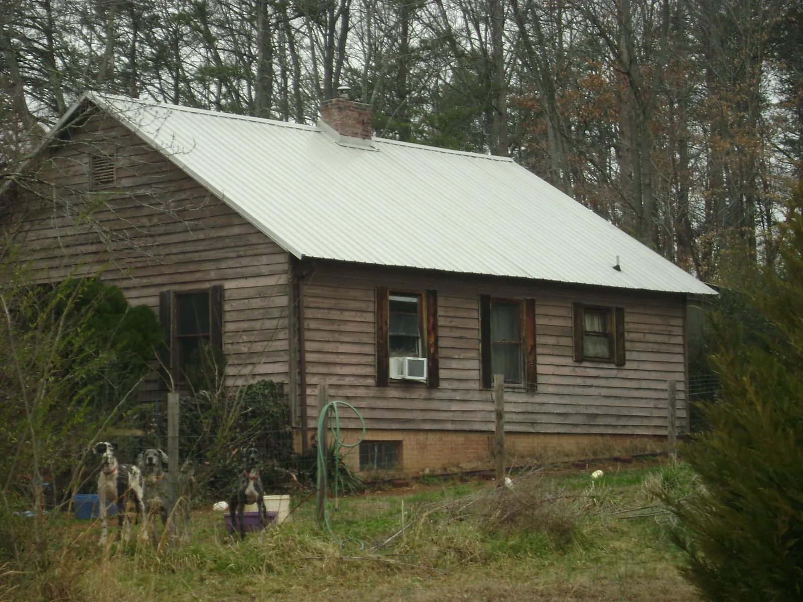 White metal roof on an old wood sided farmhouse, from a Metal Roof Installation job in Dryden